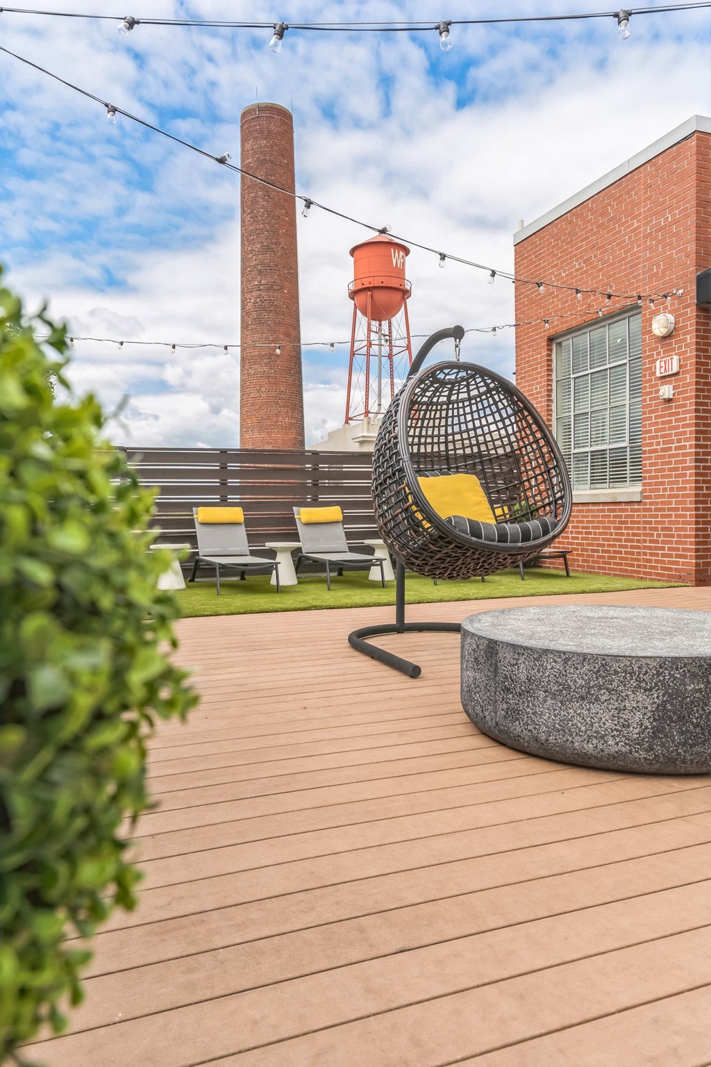a courtyard with a chair and a water tower