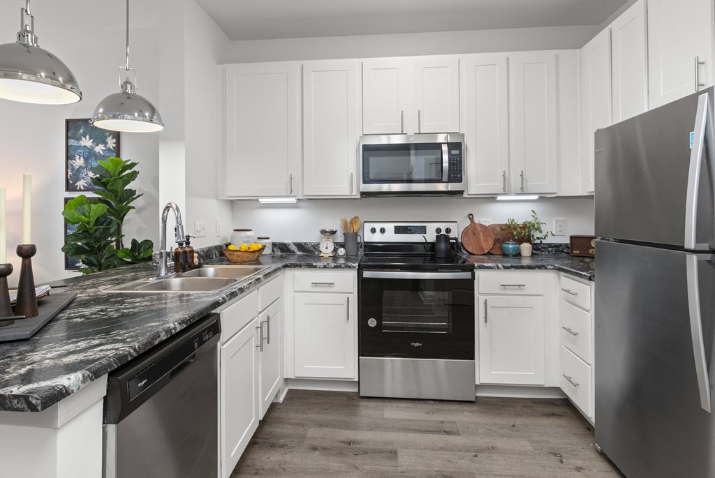 a kitchen with stainless steel appliances and white cabinets