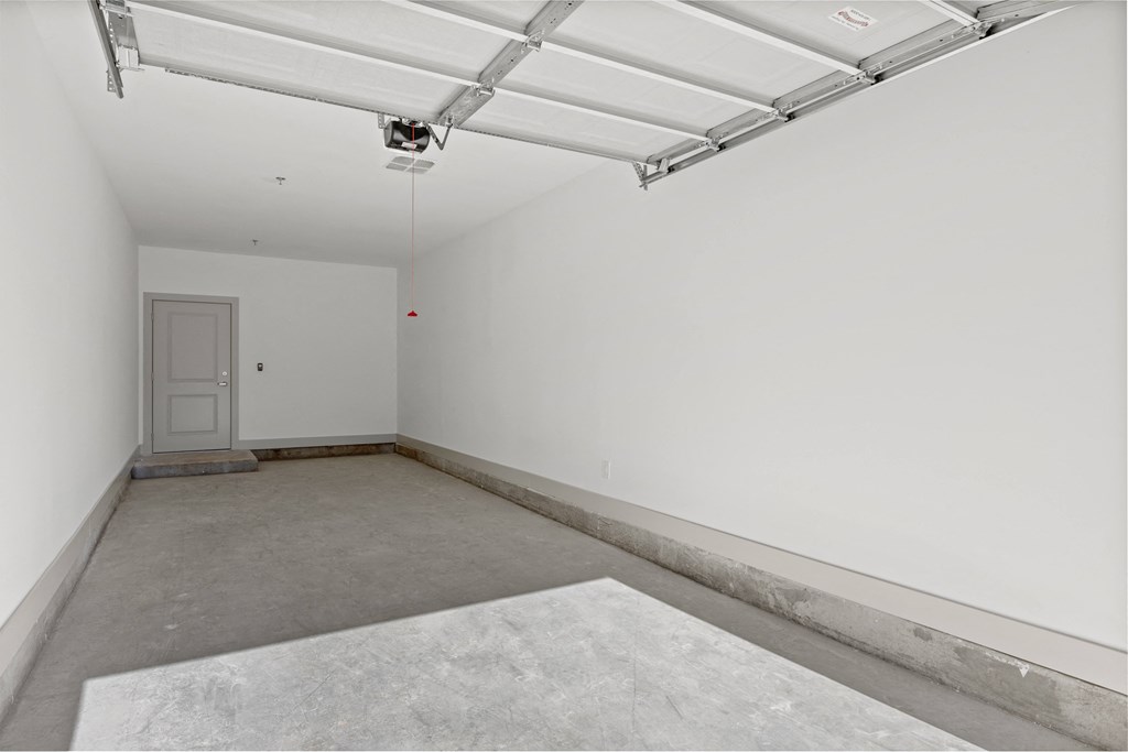 an empty room with a white wall and a door