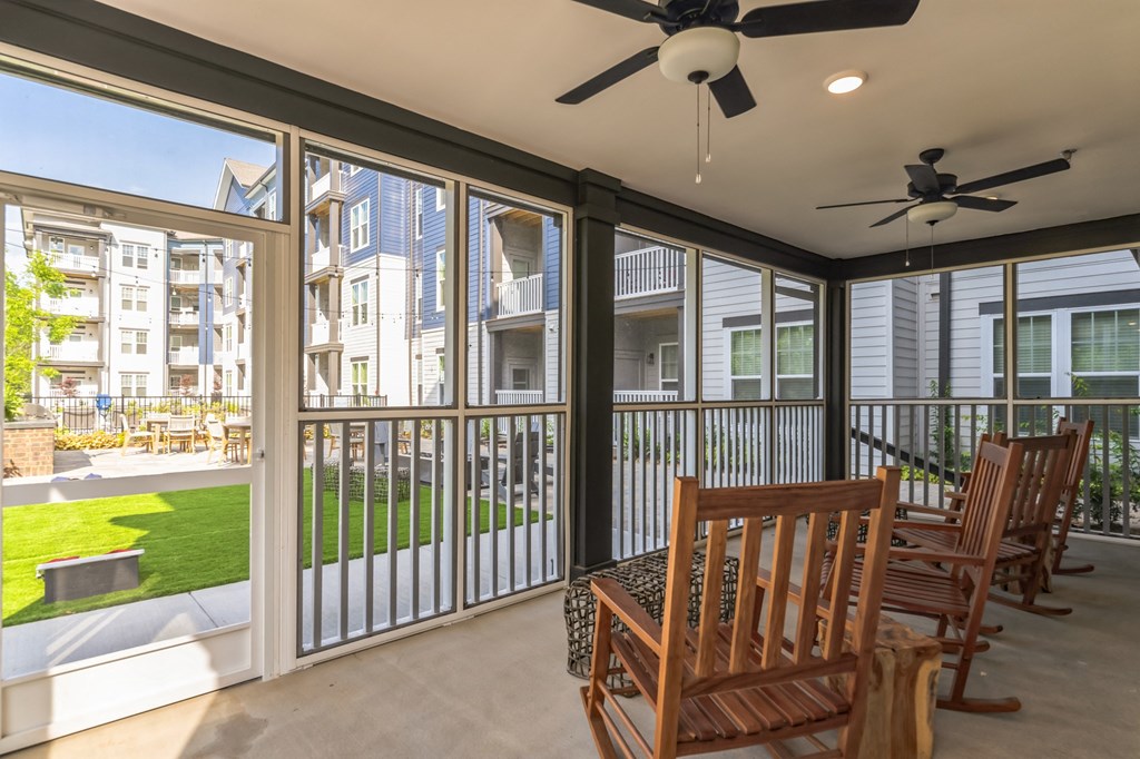 a dining area with a table and chairs on a balcony