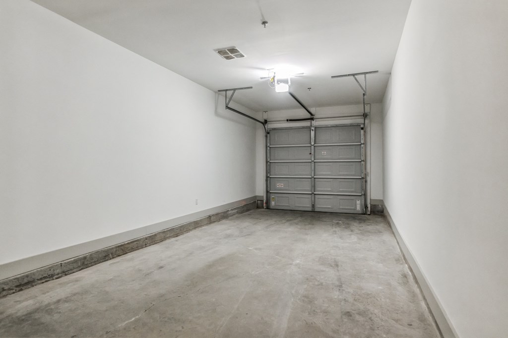 an empty room with white walls and a garage door