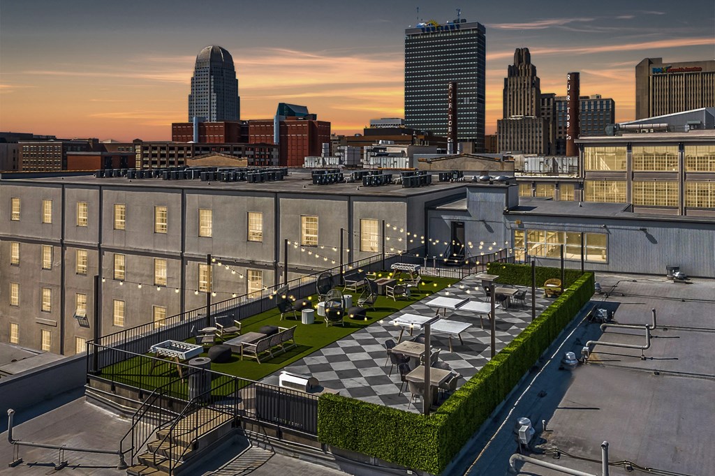 a rooftop patio with a view of the city