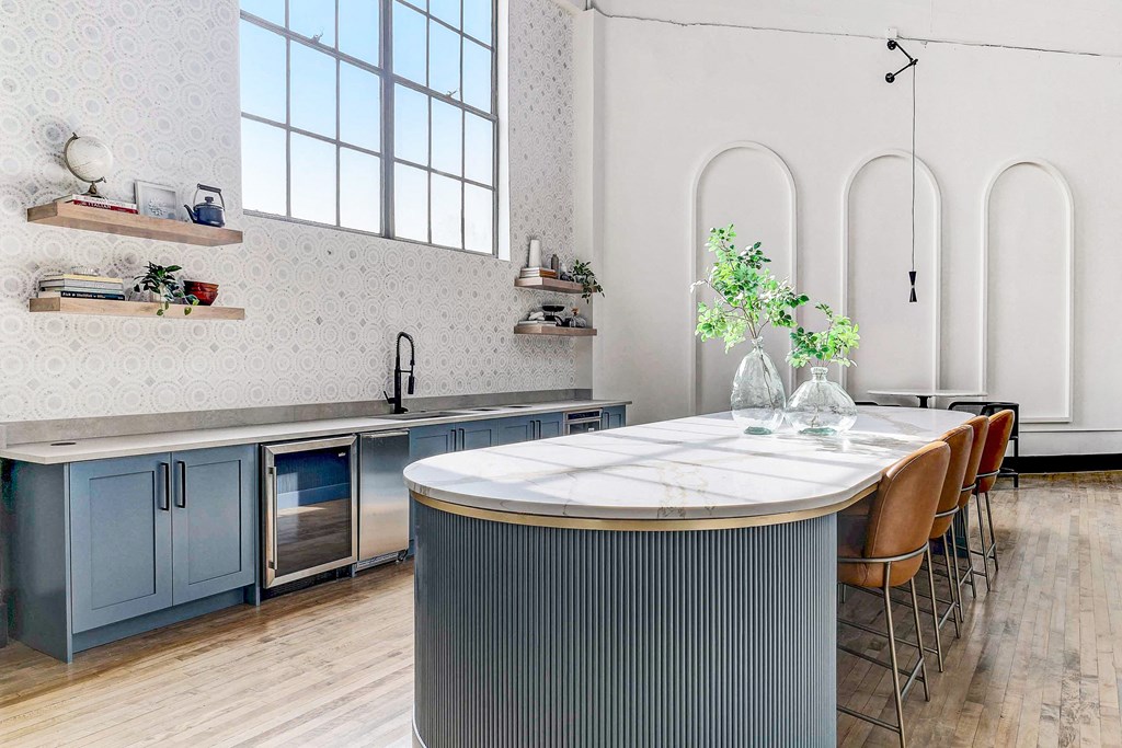 a kitchen with a large island with a marble countertop