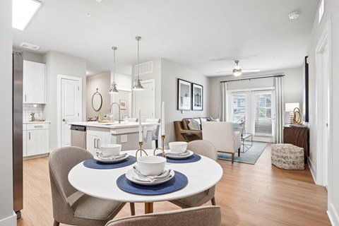 A modern dining room with a table set for two.