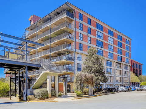a large building with many balconies and a staircase in front of it
