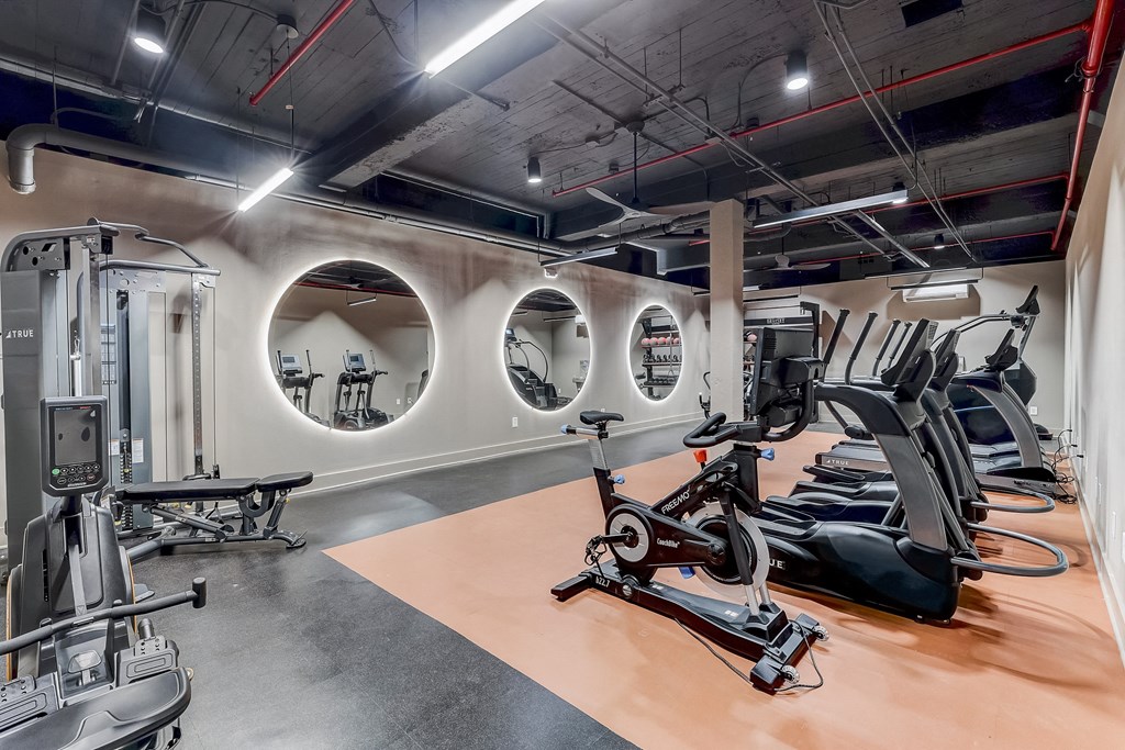 a gym with elliptical machines and other exercise equipment
