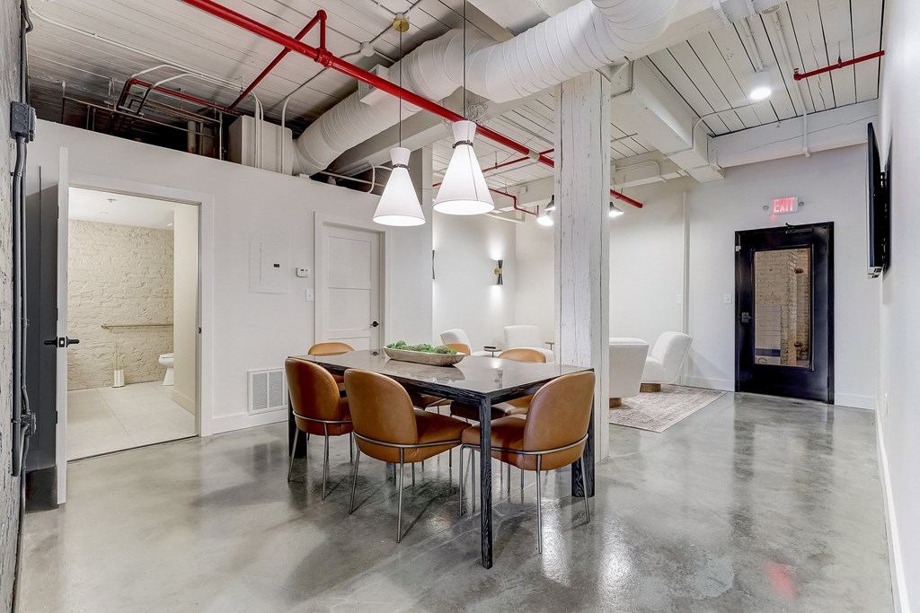 a dining area with a long table and chairs