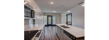 a kitchen with white countertops and white cabinets
