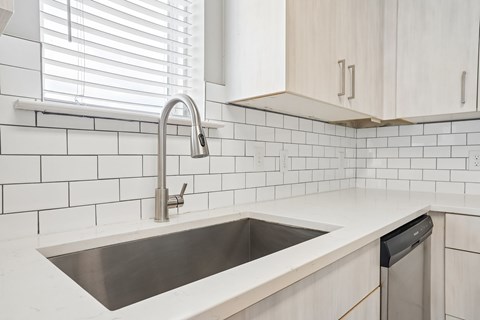 A kitchen with a sink and a window.