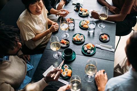 A group of people enjoying a meal together at a table.