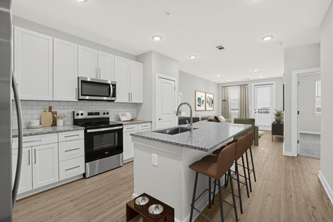 A kitchen with white cabinets and a granite countertop.
