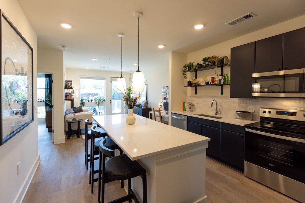 a modern kitchen with a large island and a dining room table