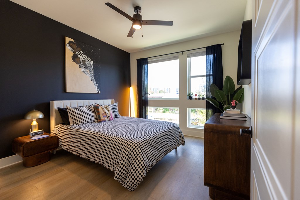a bedroom with a bed and a ceiling fan