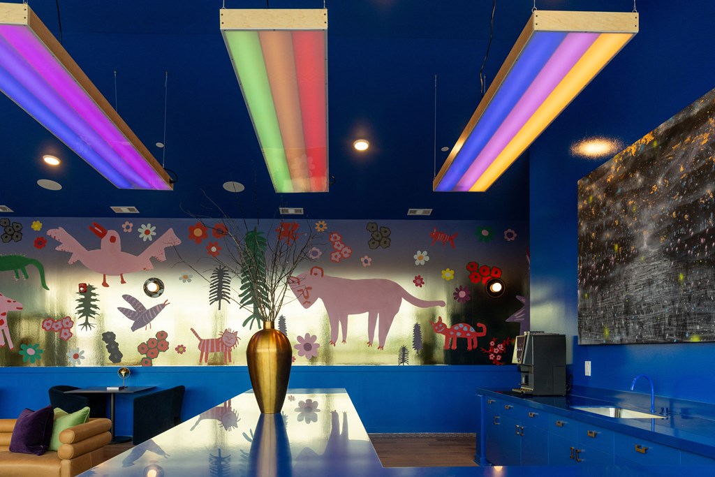 a dining room with a table and a mural of animals on the wall