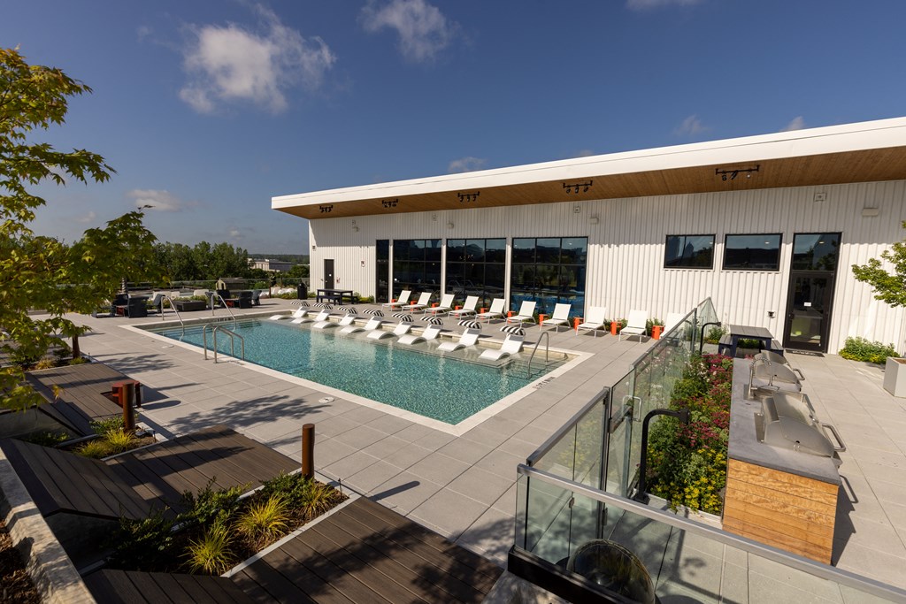 a swimming pool in front of a white building