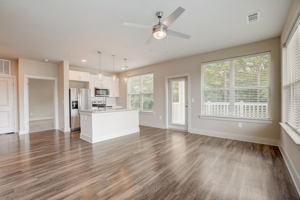 a living room with hardwood floors and a ceiling fan