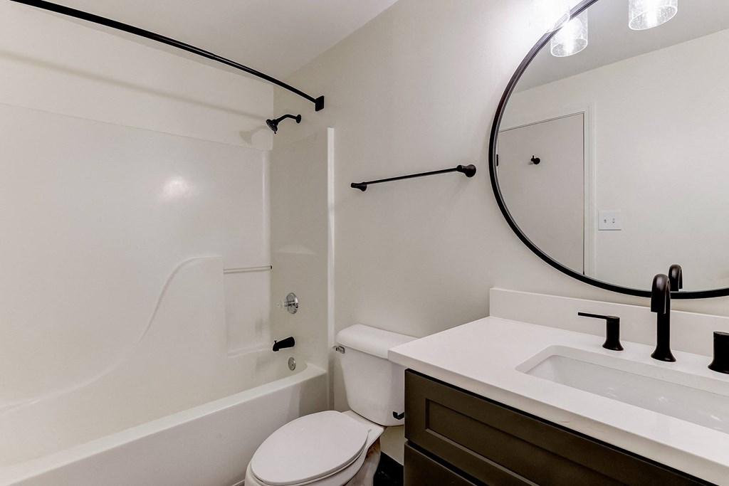 a bathroom with a toilet sink and bathtub