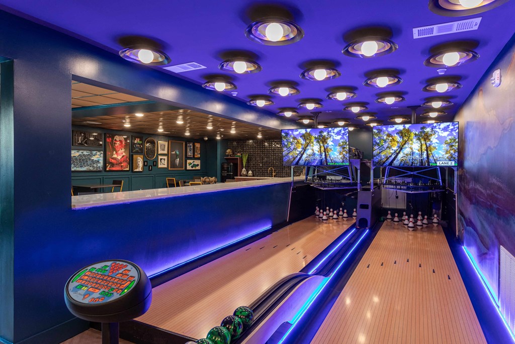 a bowling alley with a bar and bowling pins