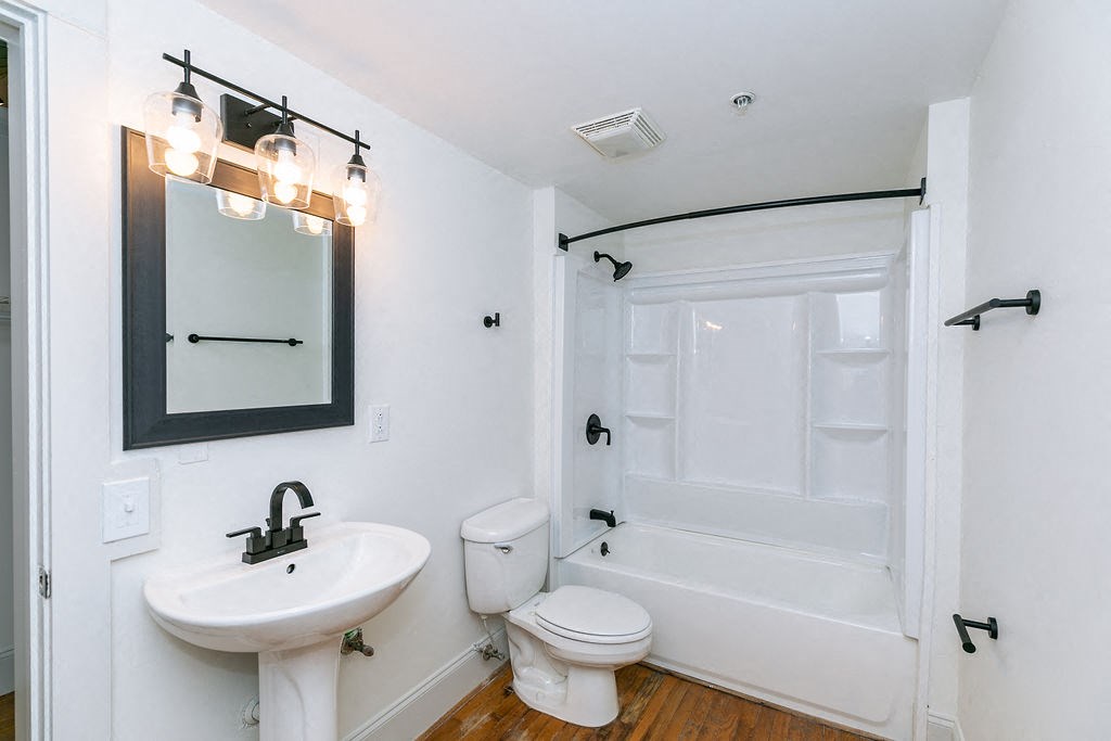 a bathroom with a sink toilet and a tub