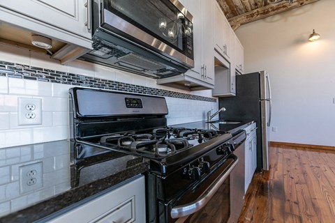 a kitchen with a stove and a microwave