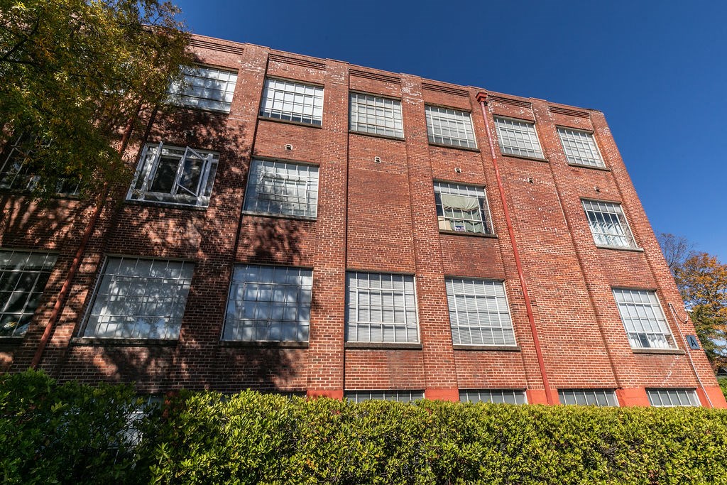 a red brick building with a blue sky in the background