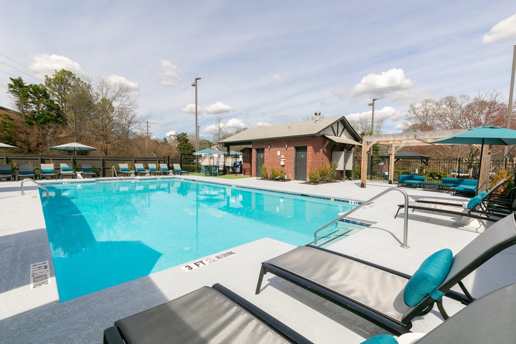 our apartments have a swimming pool with chairs and umbrellas