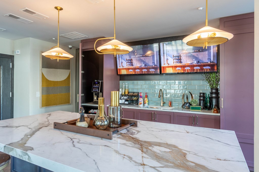 a kitchen with a marble counter top and a bar