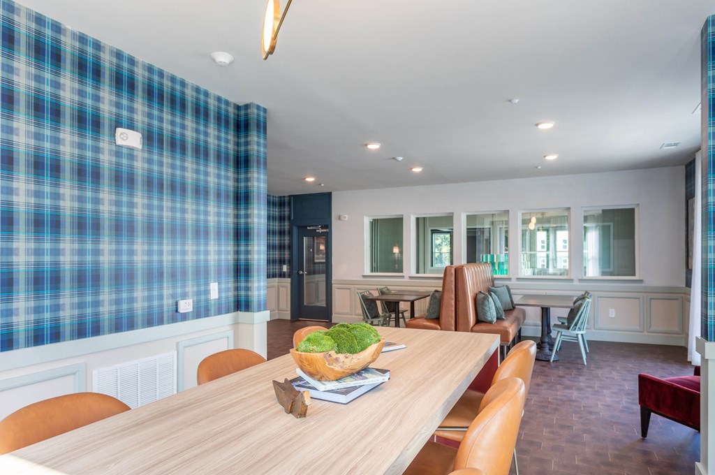 a dining room with a wooden table and chairs