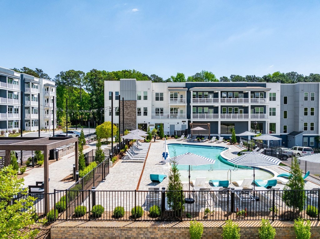 an aerial view of an apartment complex with a swimming pool