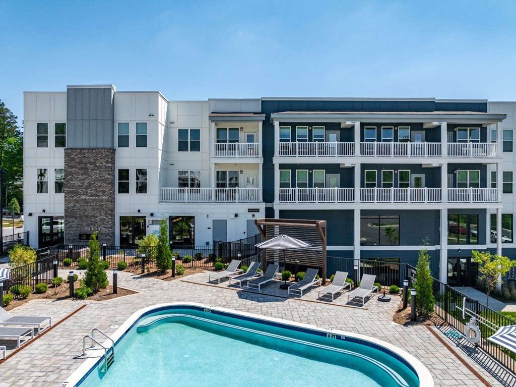 a swimming pool in front of an apartment building