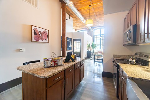 a kitchen with granite counter tops and a long counter top in the middle