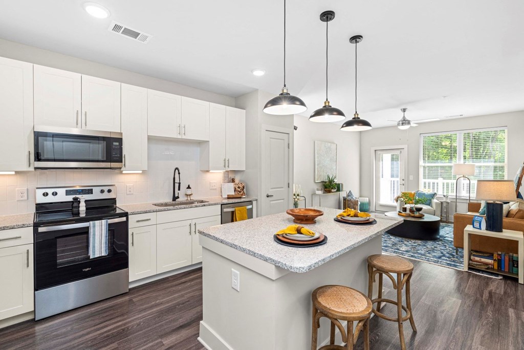 a kitchen with a large island with three stools