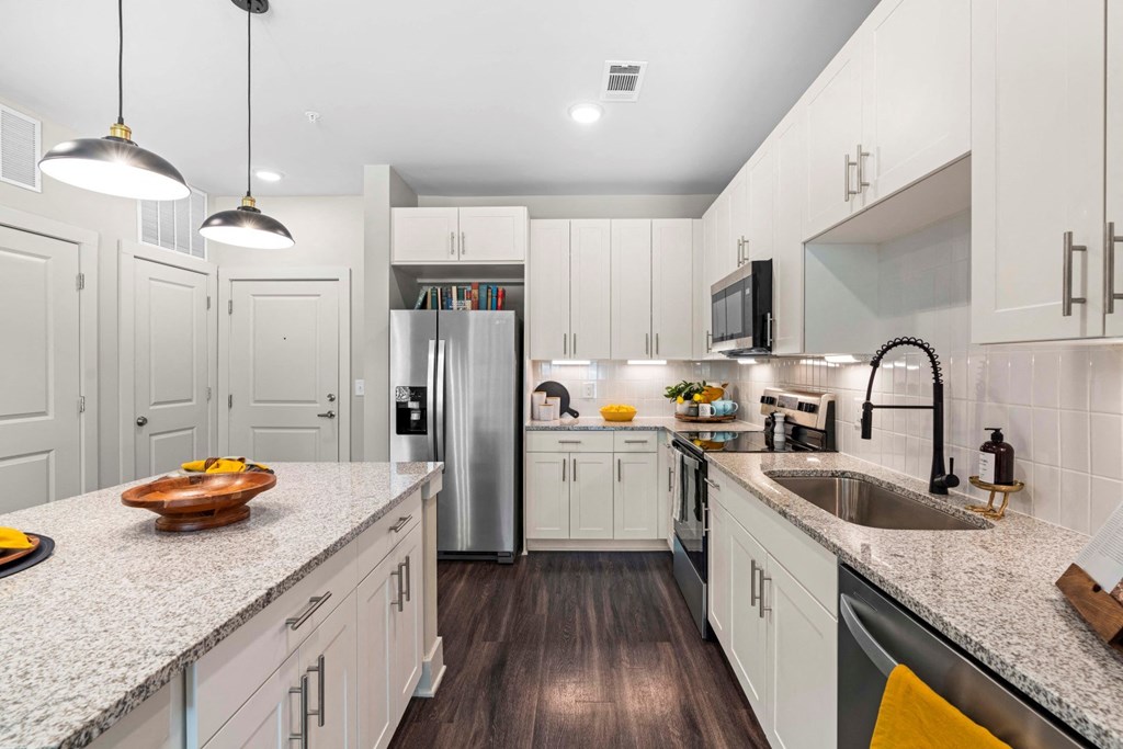 a kitchen with white cabinets and a counter top