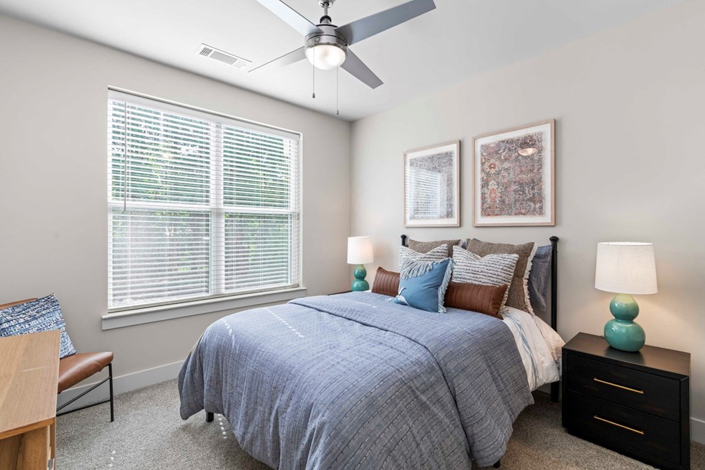 a bedroom with a bed and a ceiling fan