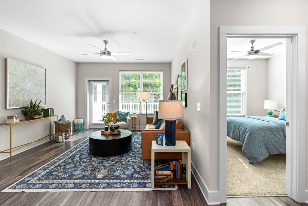 a living room with a bed and a mirror