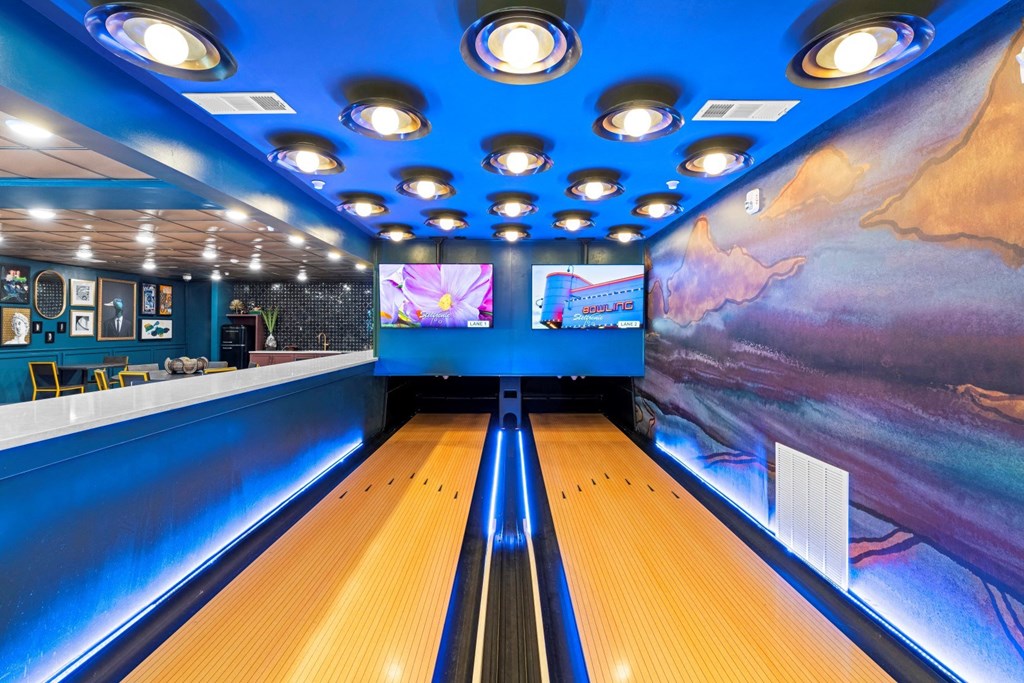 a bowling alley in a party room with bowling pins