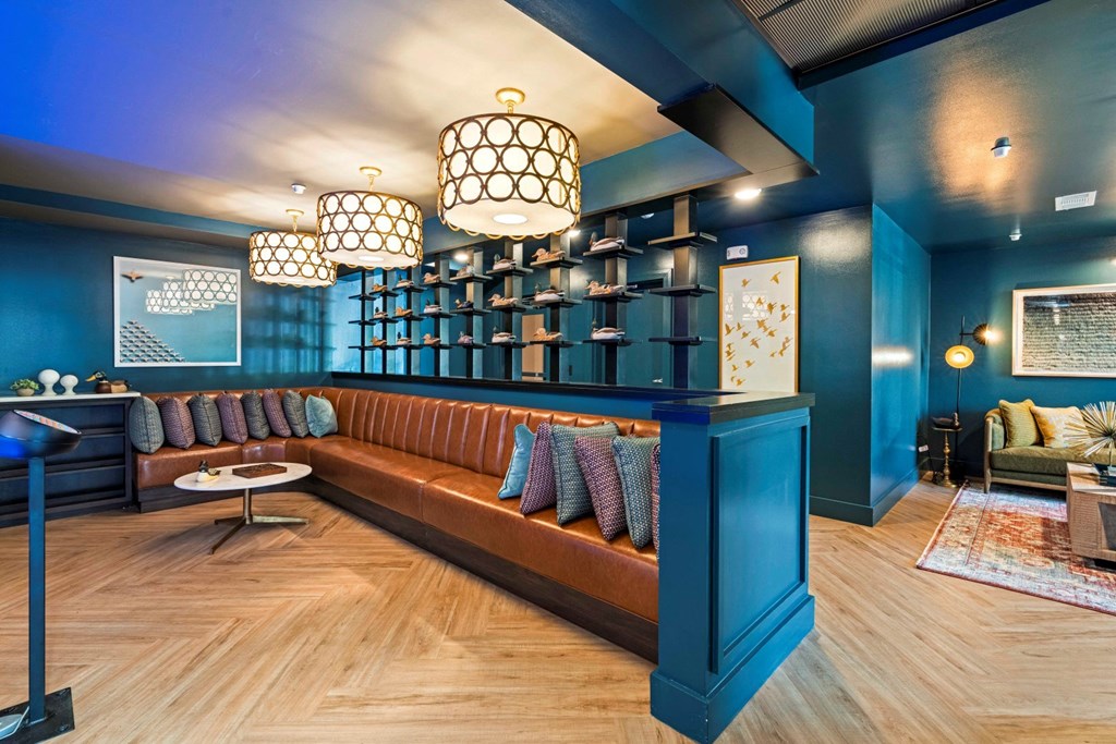 a living room with blue walls and a brown couch