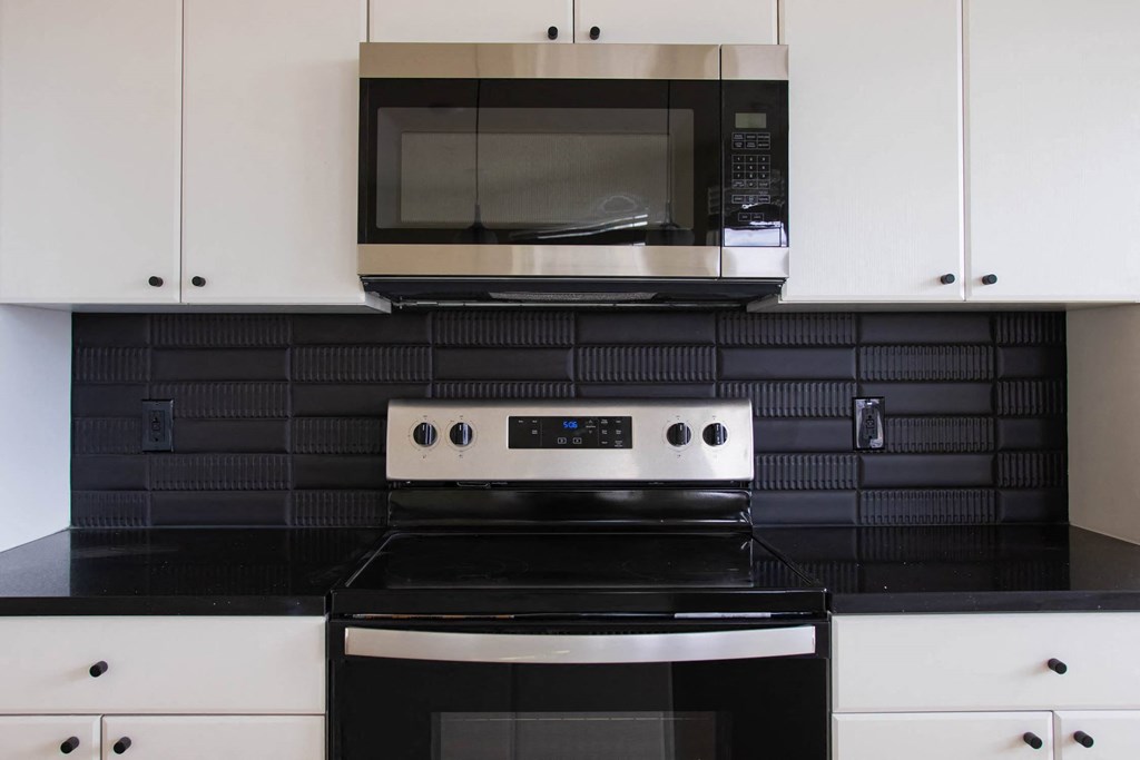 a kitchen with a stove and a microwave