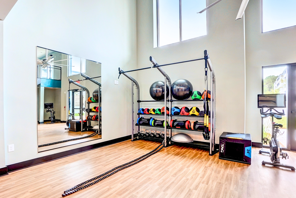 a home gym with weights and mirrors