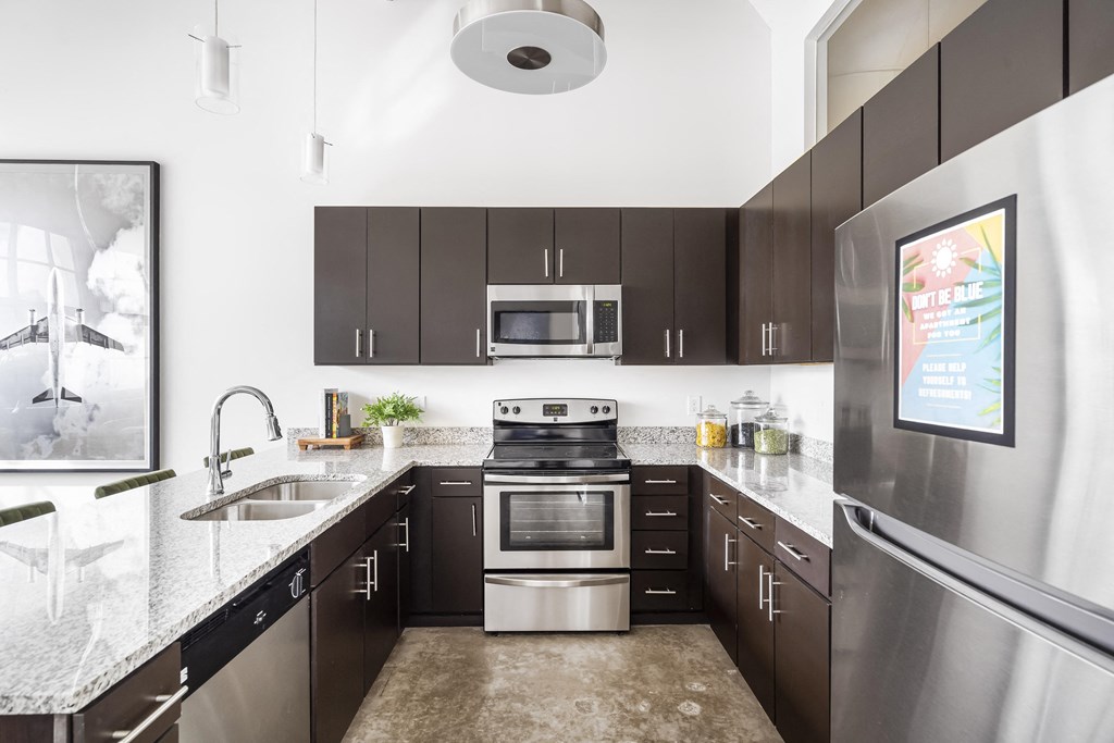 a modern kitchen with stainless steel appliances and granite counter tops