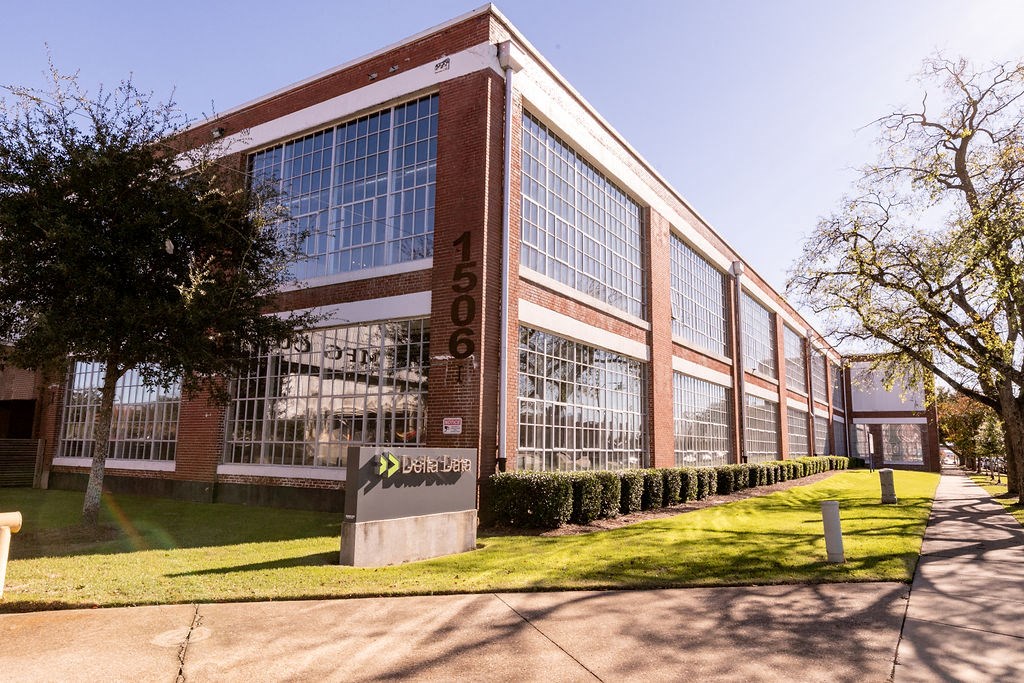 a large brick building with a sign in front of it