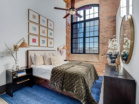 a bedroom with a bed and a ceiling fan