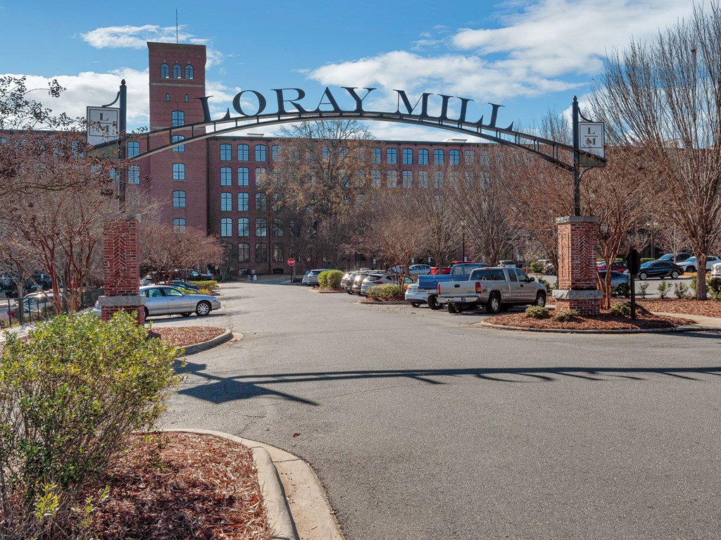 a sign that reads loray mill with a building in the background