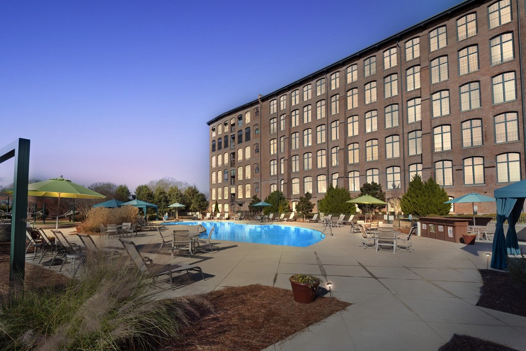 a swimming pool in front of a tall building