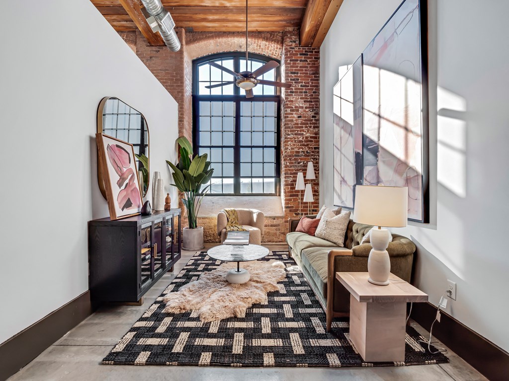a living room with a couch and a large window