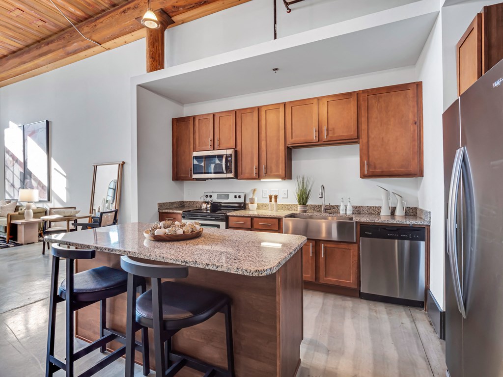 a kitchen with wooden cabinets and a granite counter top