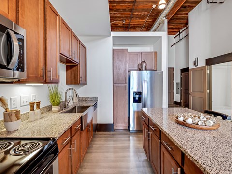 a kitchen with granite counter tops and stainless steel appliances