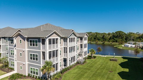 A large apartment complex with a lake in the background.