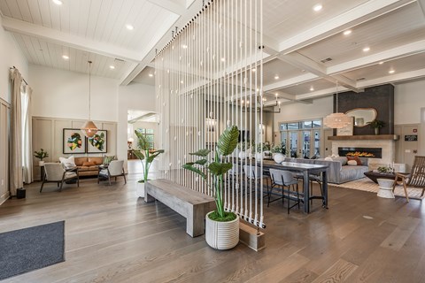 A modern living room with a wooden floor and a large window.