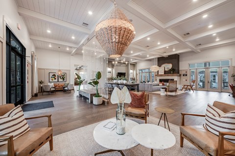 A large, well-lit room with wooden floors and furniture.